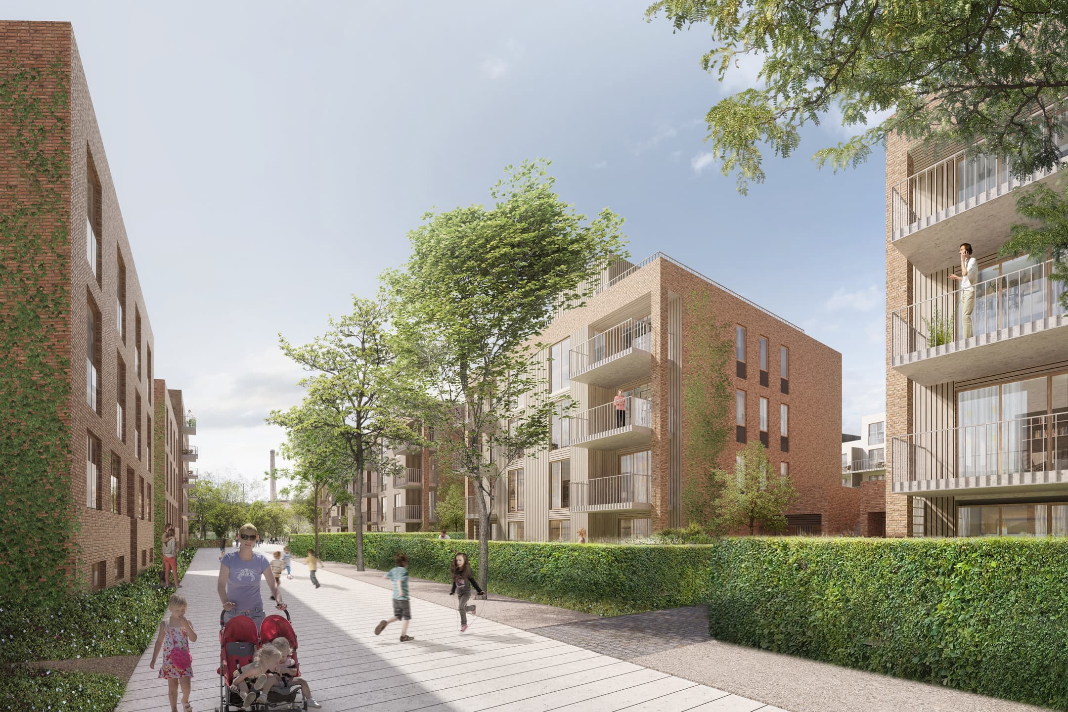 Děti a matka s kočárkem před bytovým komplexem